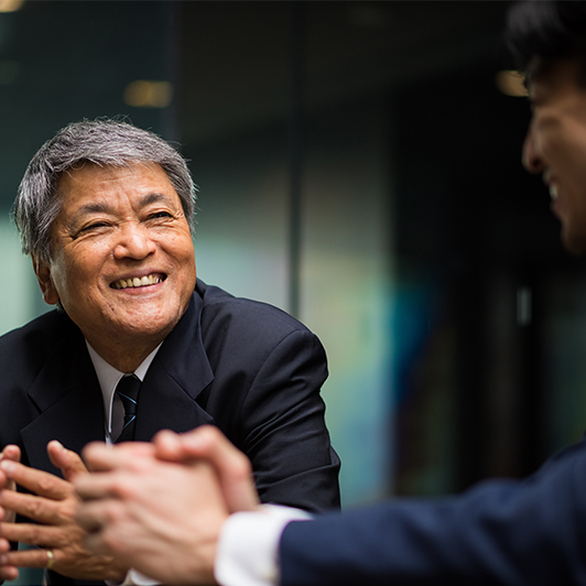 A man talking in a meeting set up.